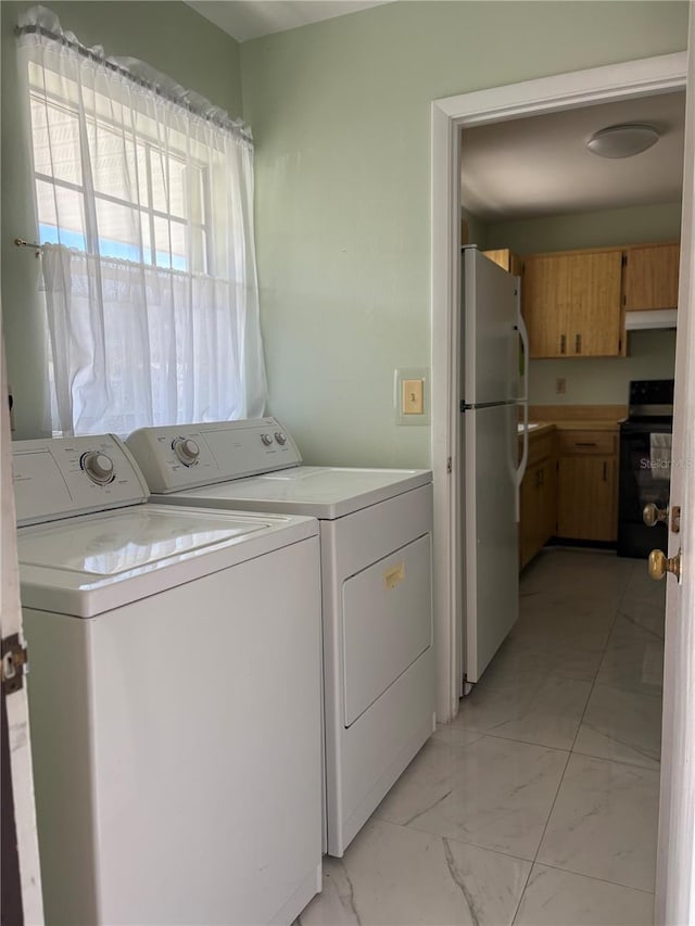 clothes washing area featuring washer and clothes dryer