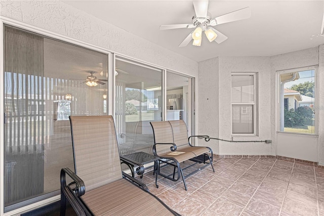 sunroom featuring ceiling fan