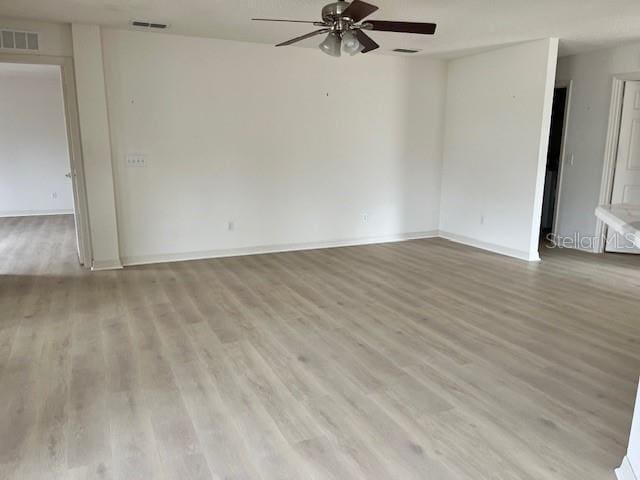 empty room featuring ceiling fan and light hardwood / wood-style flooring