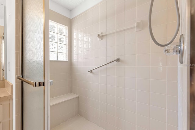 bathroom with a shower with door