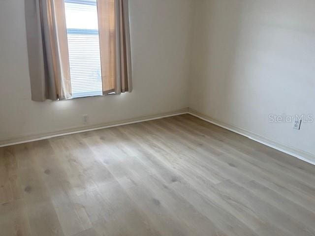 unfurnished room with light hardwood / wood-style flooring