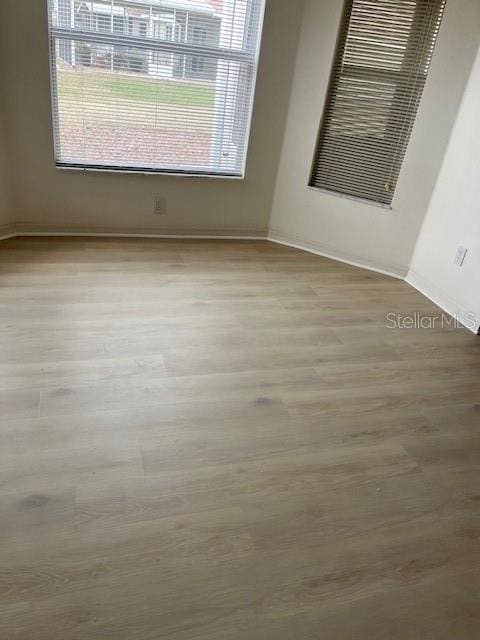 spare room featuring light hardwood / wood-style floors