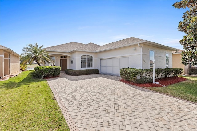 ranch-style house featuring a garage and a front yard