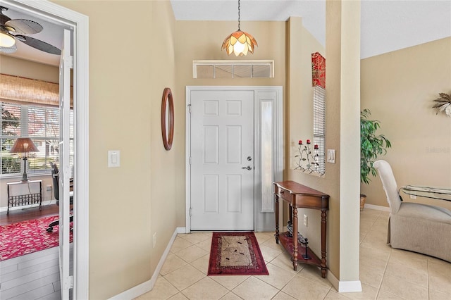 tiled foyer entrance featuring ceiling fan