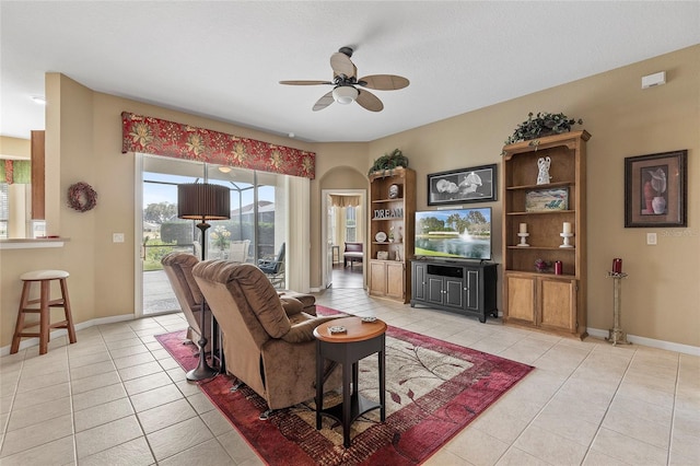 tiled living room featuring ceiling fan