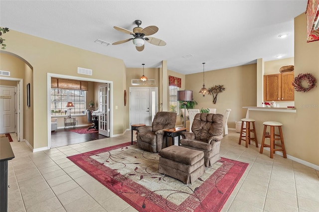 tiled living room featuring ceiling fan