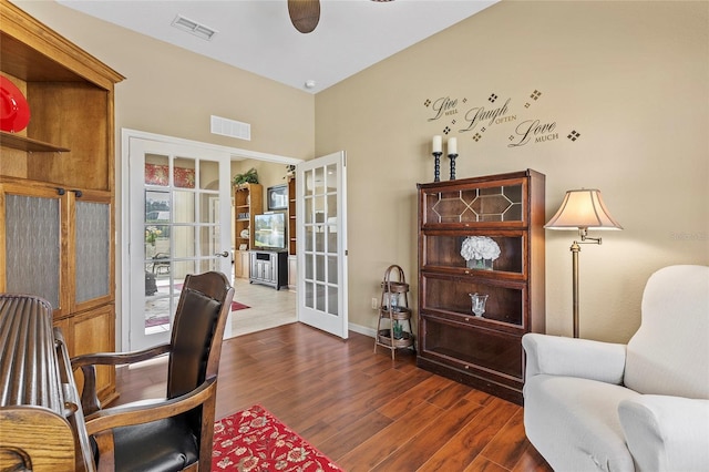 office space with french doors, ceiling fan, and dark hardwood / wood-style flooring