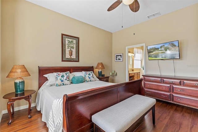 bedroom with ensuite bath, dark hardwood / wood-style floors, and ceiling fan