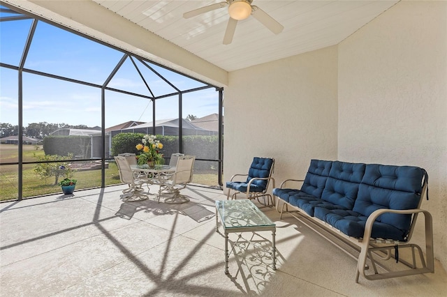 view of patio / terrace with ceiling fan, outdoor lounge area, and glass enclosure