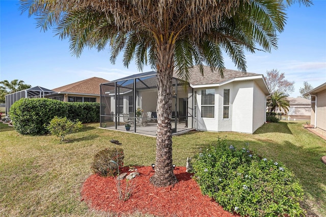 back of property featuring a patio, a yard, and glass enclosure