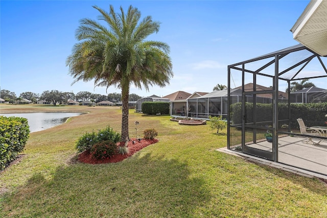 view of yard with a lanai and a water view