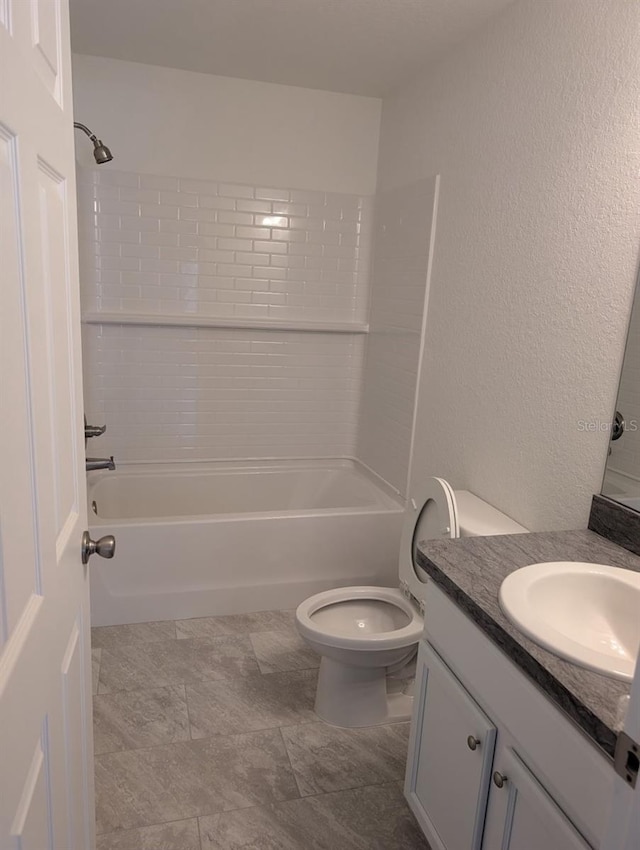 full bathroom featuring vanity, tiled shower / bath, and toilet