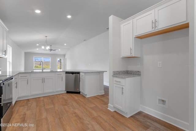 kitchen featuring white cabinets, an inviting chandelier, a sink, vaulted ceiling, and stainless steel appliances