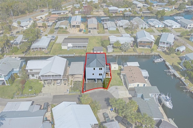 birds eye view of property with a water view and a residential view