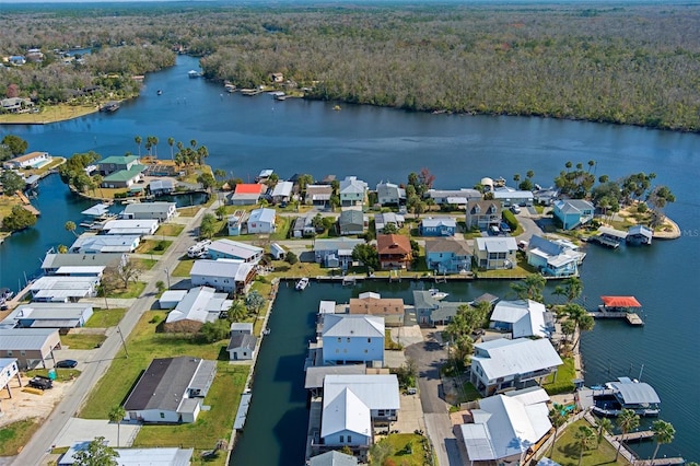 birds eye view of property with a water view, a wooded view, and a residential view