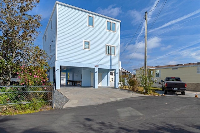 view of side of home with a carport and driveway