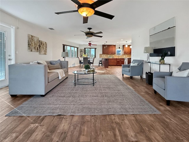 living room featuring dark wood-type flooring and visible vents