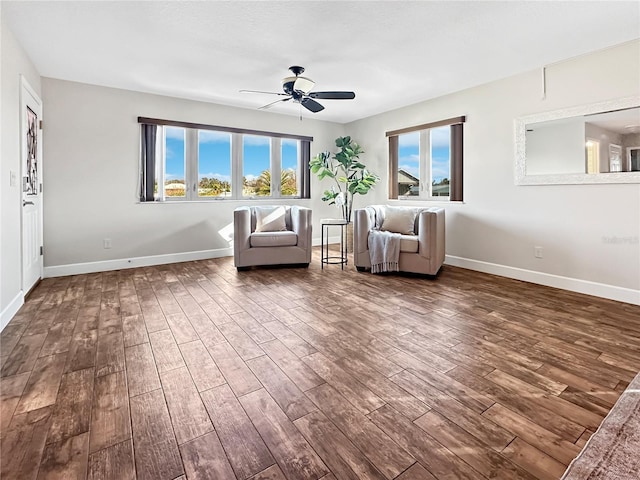 unfurnished room featuring dark wood-style floors, ceiling fan, and baseboards