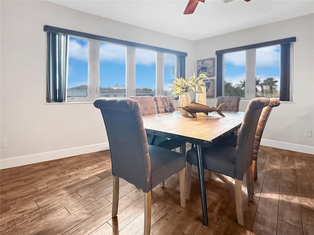 dining space with ceiling fan, baseboards, and wood finished floors