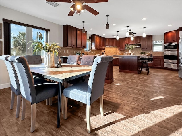 dining room with plenty of natural light, wood finished floors, visible vents, and recessed lighting