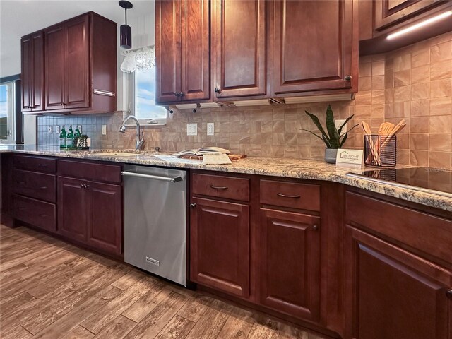 kitchen with hanging light fixtures, backsplash, stainless steel dishwasher, wood finished floors, and black electric cooktop