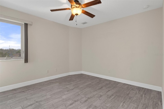 unfurnished room with light wood-style floors, ceiling fan, and baseboards