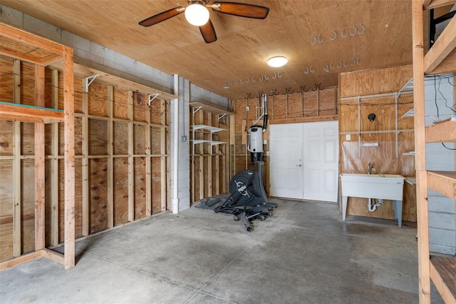 interior space with ceiling fan and a sink