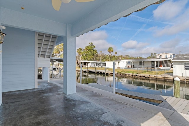 exterior space featuring a water view and a dock