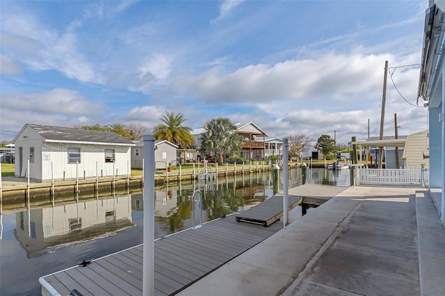 view of dock featuring a water view and a residential view