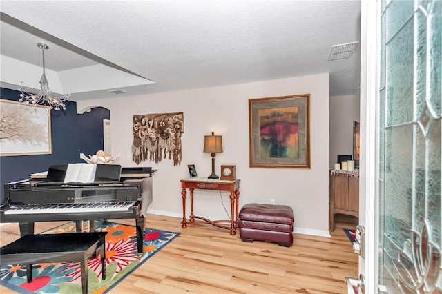 misc room featuring hardwood / wood-style flooring and a textured ceiling