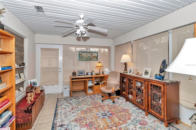 tiled home office featuring ceiling fan