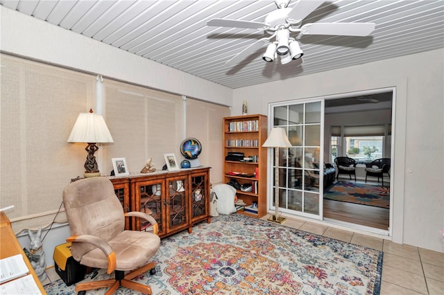 sitting room with tile patterned floors and ceiling fan