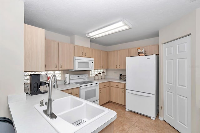 kitchen featuring light brown cabinetry, sink, white appliances, and light tile patterned floors