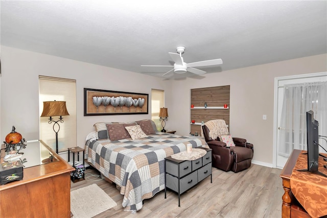 bedroom with ceiling fan and light hardwood / wood-style flooring