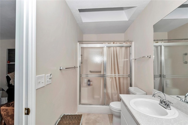 bathroom featuring vanity, toilet, and walk in shower