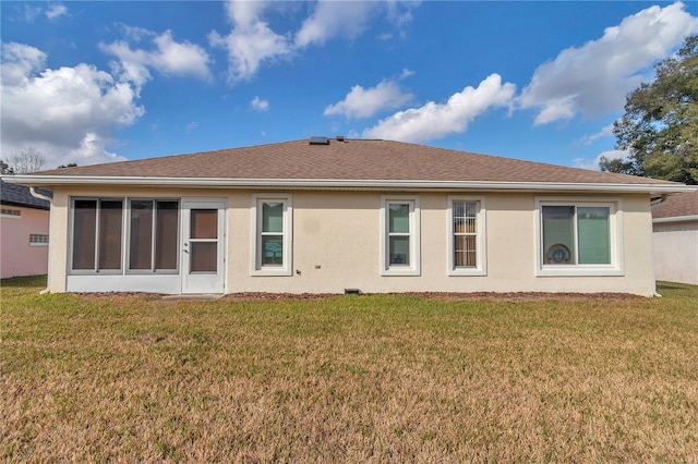 rear view of house with a lawn