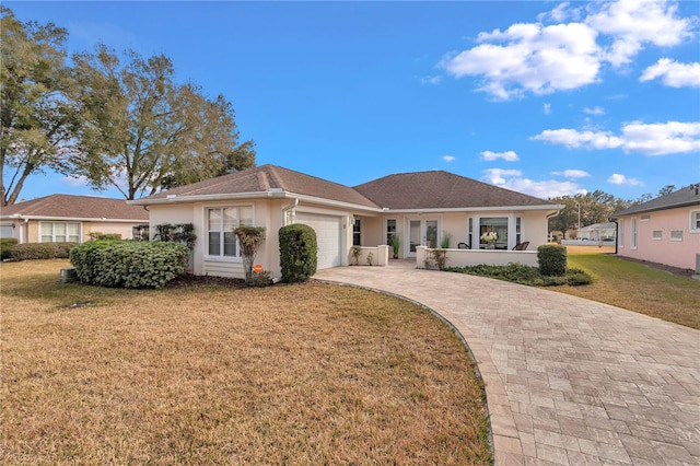 ranch-style home with a garage and a front lawn