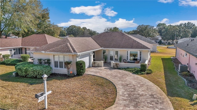 single story home featuring a garage, central AC unit, and a front lawn