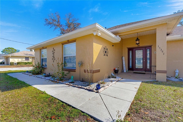 doorway to property with a yard