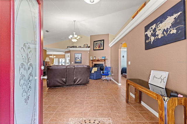 tiled living room with vaulted ceiling and a chandelier