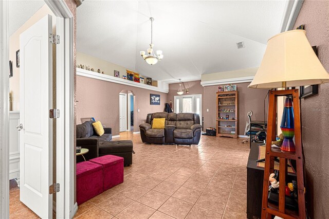 living room featuring an inviting chandelier, vaulted ceiling, and tile patterned floors