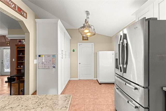 kitchen with white cabinetry, stainless steel fridge with ice dispenser, and light tile patterned floors