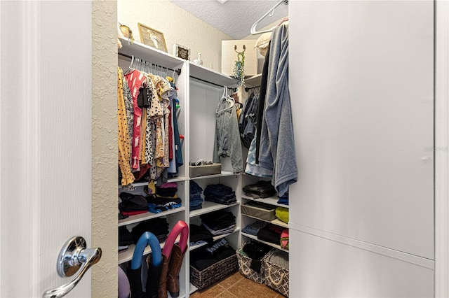 spacious closet featuring tile patterned floors