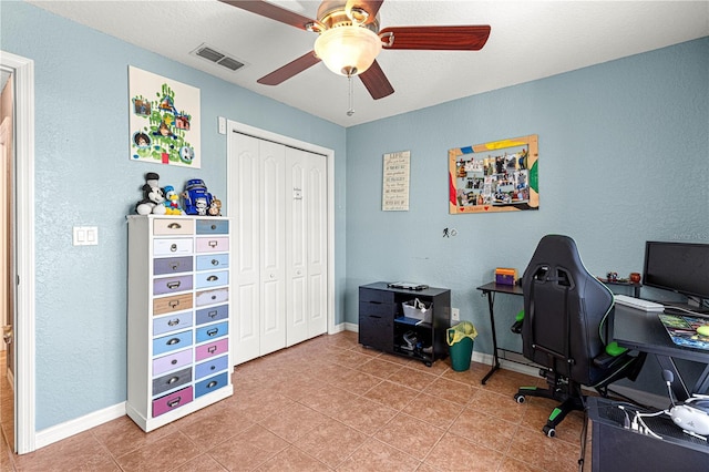 tiled office featuring ceiling fan