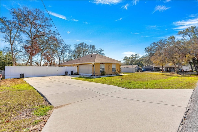 view of front facade featuring a garage and a front lawn