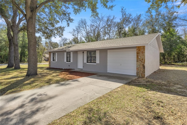 single story home featuring a garage and a front yard