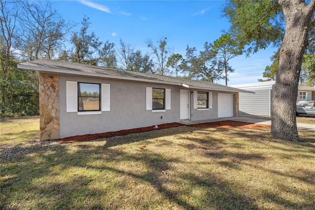 ranch-style house featuring a garage and a front lawn