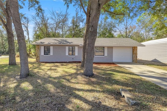 single story home featuring a garage and a front lawn