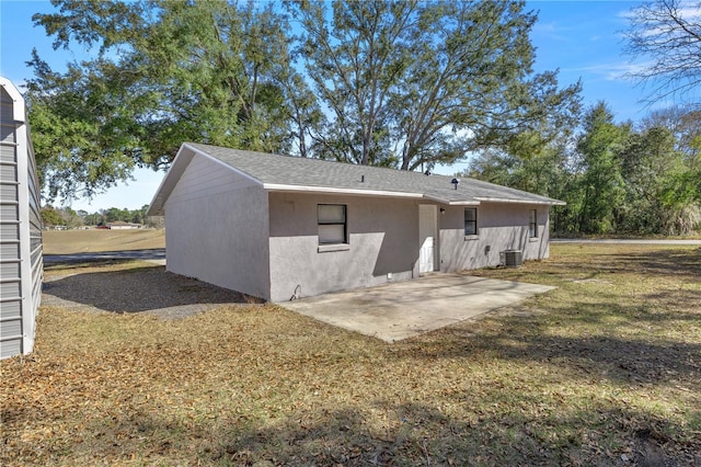 back of house featuring a patio, a yard, and central AC unit