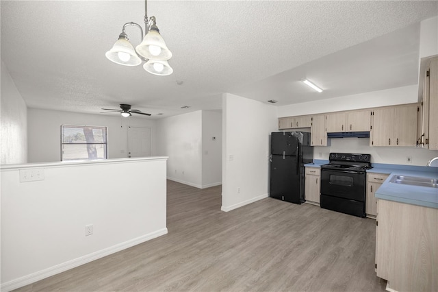 kitchen with sink, hanging light fixtures, light hardwood / wood-style floors, black appliances, and light brown cabinets